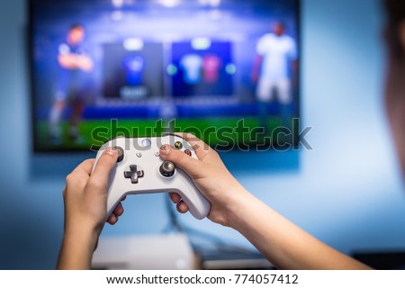 Debrecen, Hungary, 19. November 2017 View from the top on xbox one s gamepad, game console, kid holding in his hands Royalty-Free Stock Photo #774057412