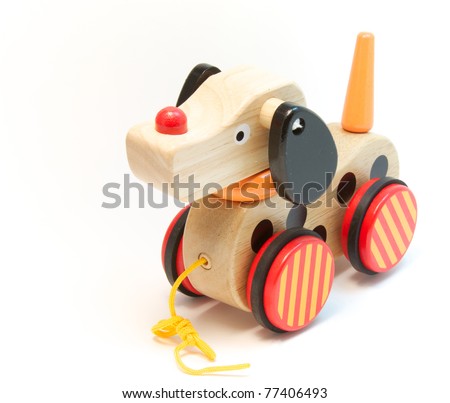 A child's wooden toy dog