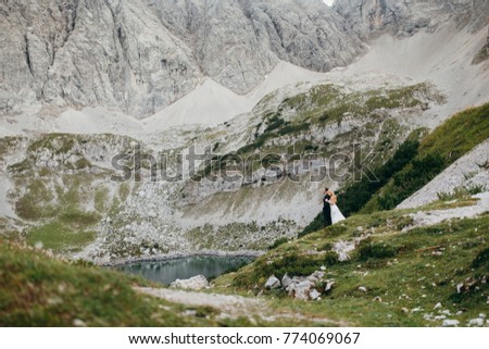 Young and beautiful couple walk on their wedding day at the Alps