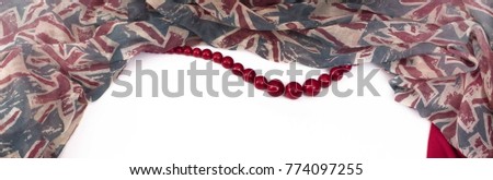 Banner feminine draped scarf and red beads. Top view flat lay