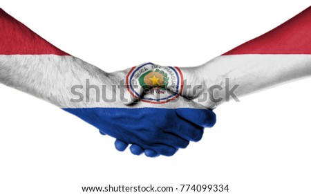Man and woman shaking hands, wrapped in flag pattern, Paraguay