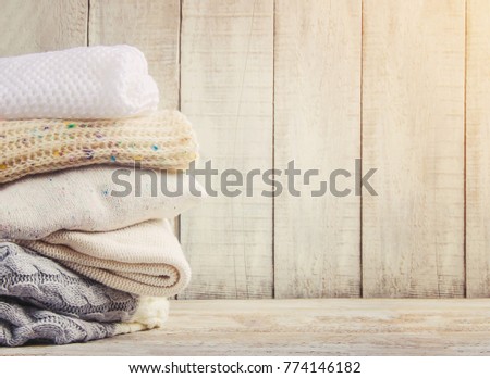 Warm Winter Clothes on a wooden background. Selective focus. 