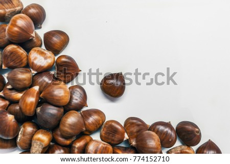Chestnuts on a blank (white) background. Sweet chestnut. Hippocastanum isolated. Pile of fresh chestnuts ready to roast shot over white background. Top view, copy space.