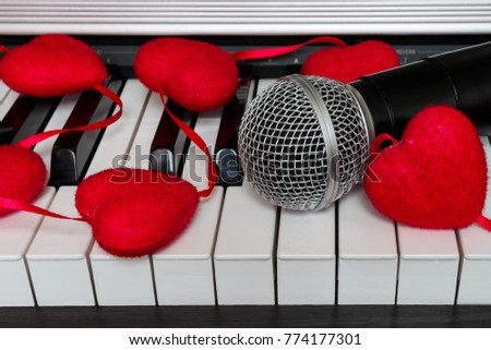 Musical instrument piano and microphone with decoration garland of hearts concept of romance, love and holiday of Valentine's Day