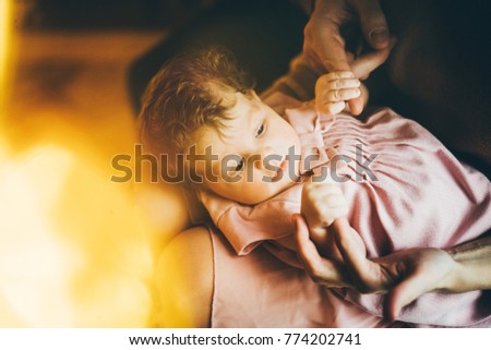 Closeup portrait infant baby. newborn baby grasping parents fingers.