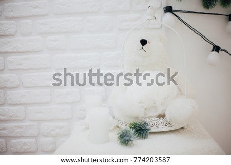 bear toy sitting on background of a white wall 
