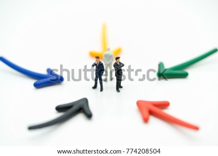 Miniature people: Businessman standing with arrow pathway choice using as Business decision concept.