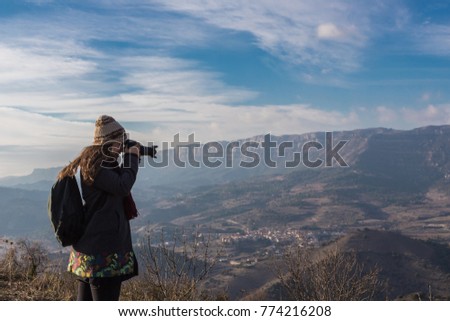 Woman photographing surreal landscape high in the mountains of Siurana, Spain
