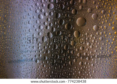 A unique background of drops on the glass. Bright background of drops on the glass.