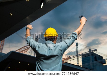 Asian welcome smile Engineering manager, field engineer, foreman celebrate after construction site project complete on time. Business teamwork success concept on city background Royalty-Free Stock Photo #774239647