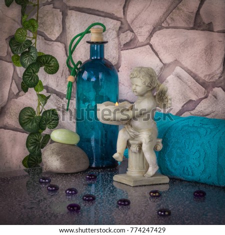 Decoration of bathroom in blue colors and classical style with angel on the background of  rough stone.