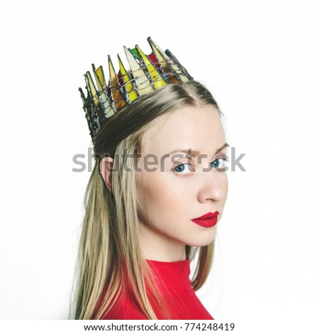young beautiful blonde girl with long hair and blue eyes with a stained glass crown on her head