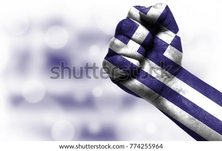 Flag of Greece painted on male fist, concept of conflict