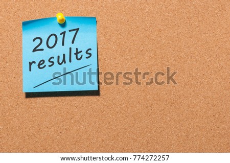 2017 results text on a blue note pinned at cork board with empty space for text. Review of the year