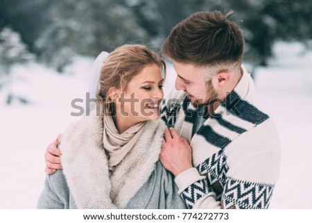 Winter day. Photo of happy man and woman outdoor in winter