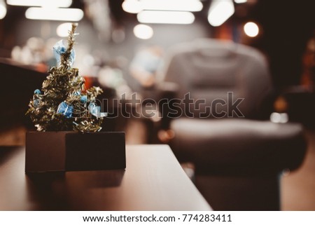 Barbershop. Christmas tree with gifts on background of barber chair with business card.