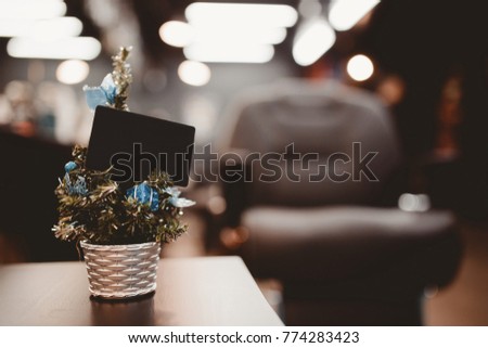 Barbershop. Christmas tree with gifts on background of barber chair with business card.