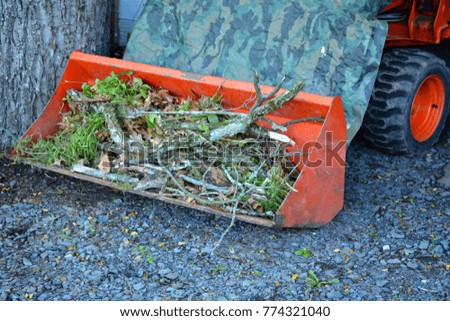 Loader Bucket Filled with Debris from Garden