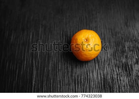 Tangerines on a black background. Lots of fresh fruit - mandarins. High quality photo