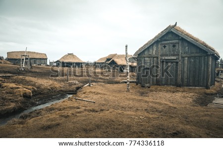 Viking village In Iceland, which is located in a beautiful setting and consists of several houses with a palisade wall.