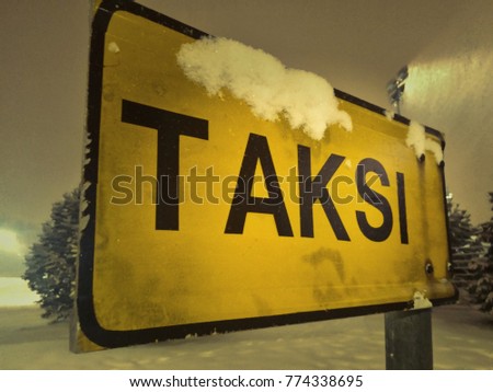 A taksi taxi sign.