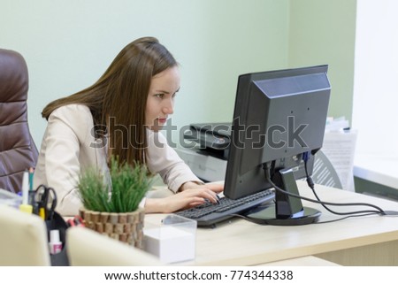 Young business woman working hard over the Desk in the study, economist accountant financial reporting, verifies accuracy of documents. Severe mental work.