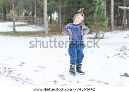Kid having fun time in winter snow