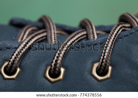 Fragment of blue shoes with  wicker laces.