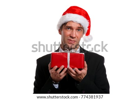Photo of young man in business suit, Santa cap with gifts in box