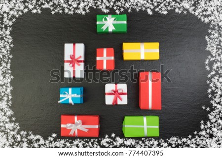 Gift boxes and colorful present for christmas on blackboard. Top view with copy space