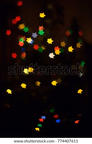 Colorful light bulbs and vivid round bokeh lights tree festive mood lightning. Form of a star. Colorful.