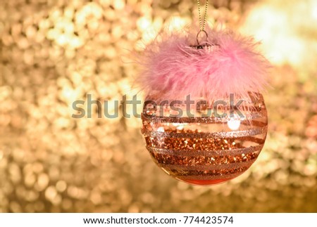 Christmas ornament, decoration, golden ball. Golden background with bokeh.