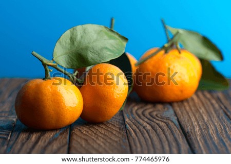 Juicy ripe tangerines on a wooden table