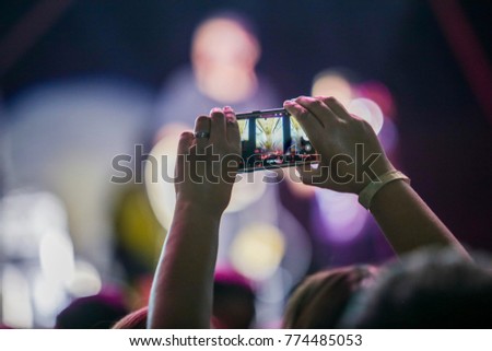 religious live concert and people enjoying, raising their hands and taking pictures