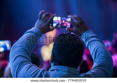 religious live concert and people enjoying, raising their hands and taking pictures
