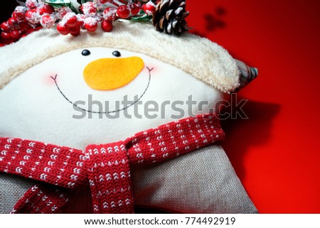 New year Snowman. Merry Christmas gift on red background. Christmas decor. Smiling Snowman.