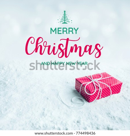 Merry christmas and happy new year text with gift box,present on snow background.For festival and celebration concepts ideas.Top view