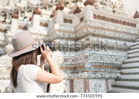 Female shooting phot os at Wat Arun, Temple of Dawn in Bangkok, Thailand