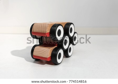 Stack of wooden toy cars with shadow in perspective view.  Six wheels for arrow sign isolated on white background for concept.