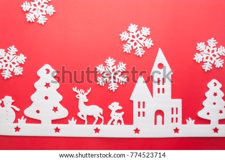 Merry Christmas and Happy New Year. Foam cutter of City with snow flake, art and craft style on red color paper