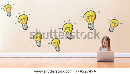 Light Bulbs with little girl using a laptop computer on floor