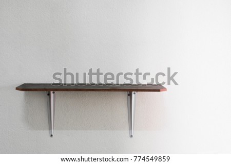 Photos of wooden shelf on gray wall