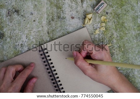 Pencil and pencil sharpener on notebook