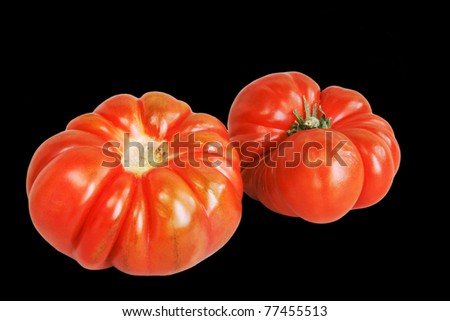 Fresh tomatoes isolated over black background