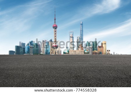 clean asphalt road with city skyline background,shanghai,china.
