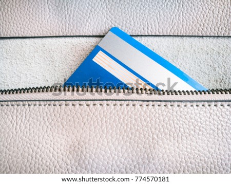 the credit card in the zipper of the wallet