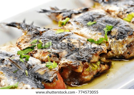 Greek Grilled Sardines with vegetables. Pantremenes