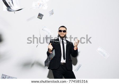 Businessman standing in the rain of money