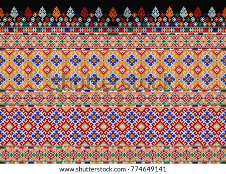 CLOSE UP THE SEAMLESS PATTERN OF COLORFUL CLOTHES.  THE HANDMADE EMBROIDERY DID BY HILL TRIBE WOMEN.