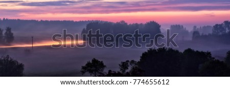 illuminated blurred road  - long exposure misted landscape while sunset